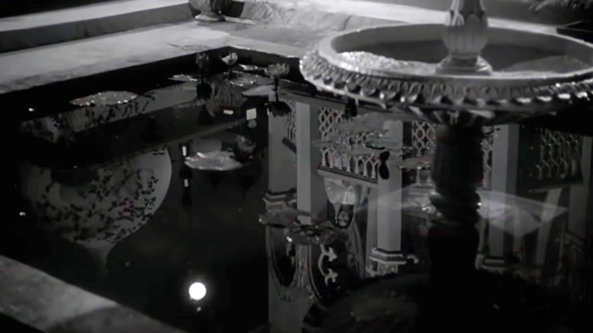 The reflection in water captures both the moon and Waheeda Rehman together