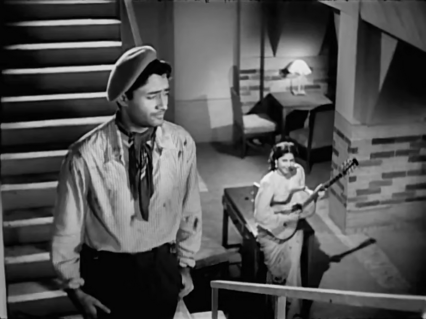 Dev stands at the top of a staircase in Baazi