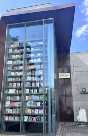Exterior view of Kitabgah bookstore with floor-to-ceiling glass walls at Arthshila Patna